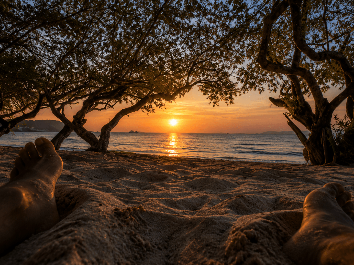 Feet in the sand at sunset, Tien Beach